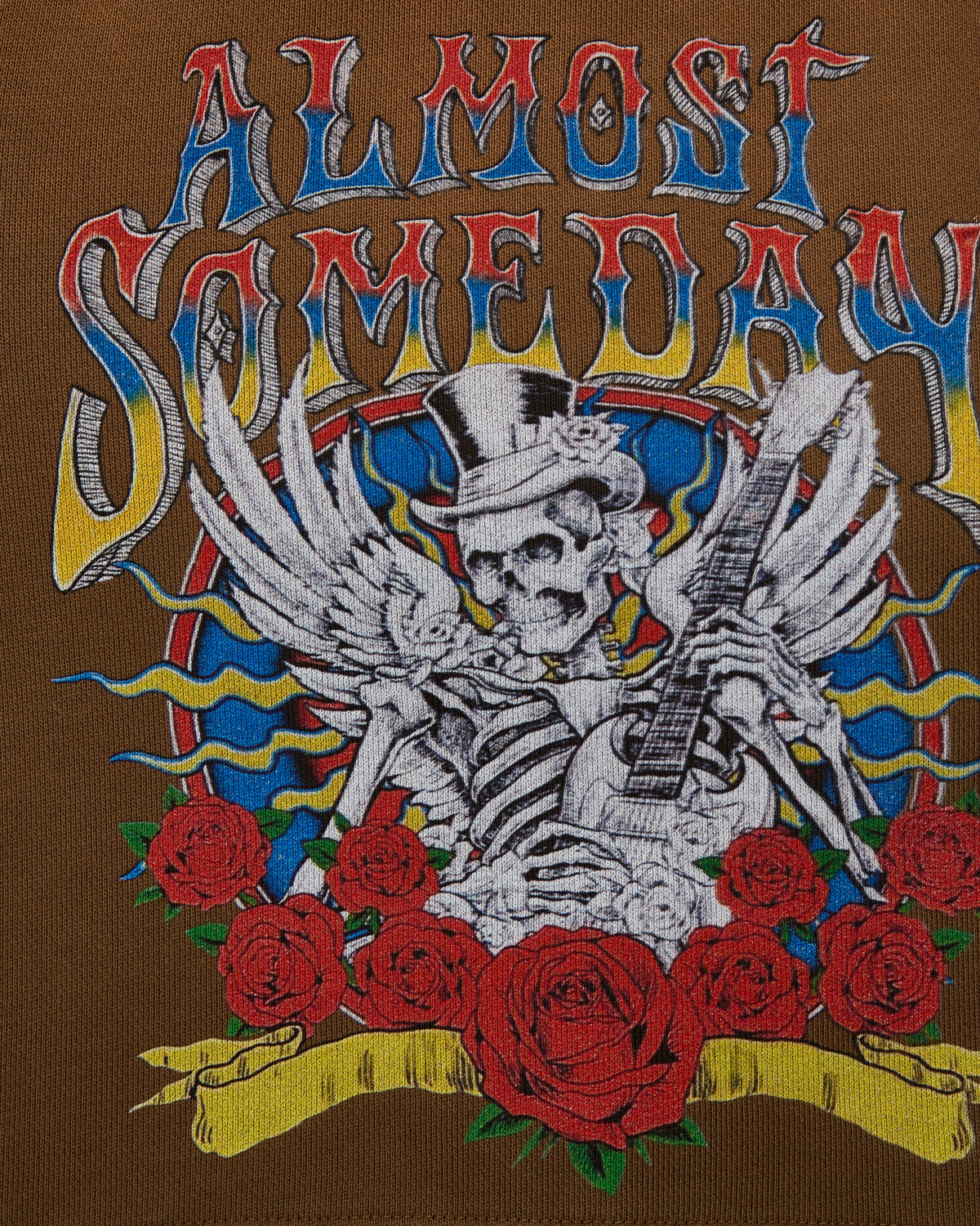 Embroidered design on a brown background featuring a skeleton with a guitar, roses, and colorful text.