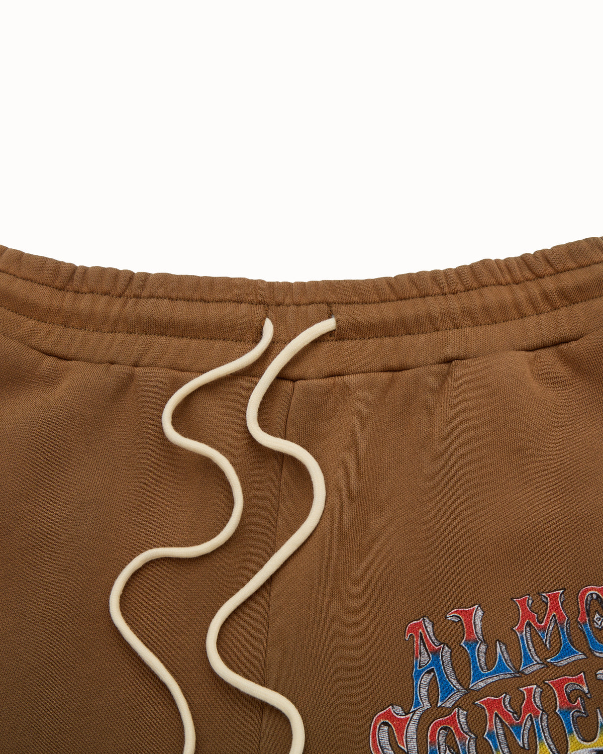 Brown sweatshorts with a colorful text design on a white background
