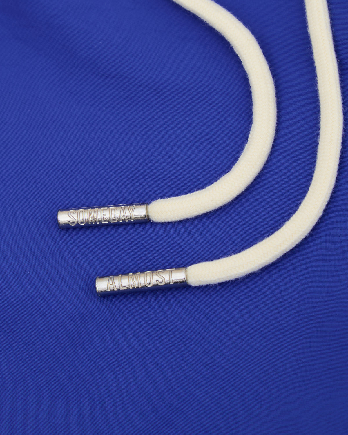 White cord with silver ends on a blue background