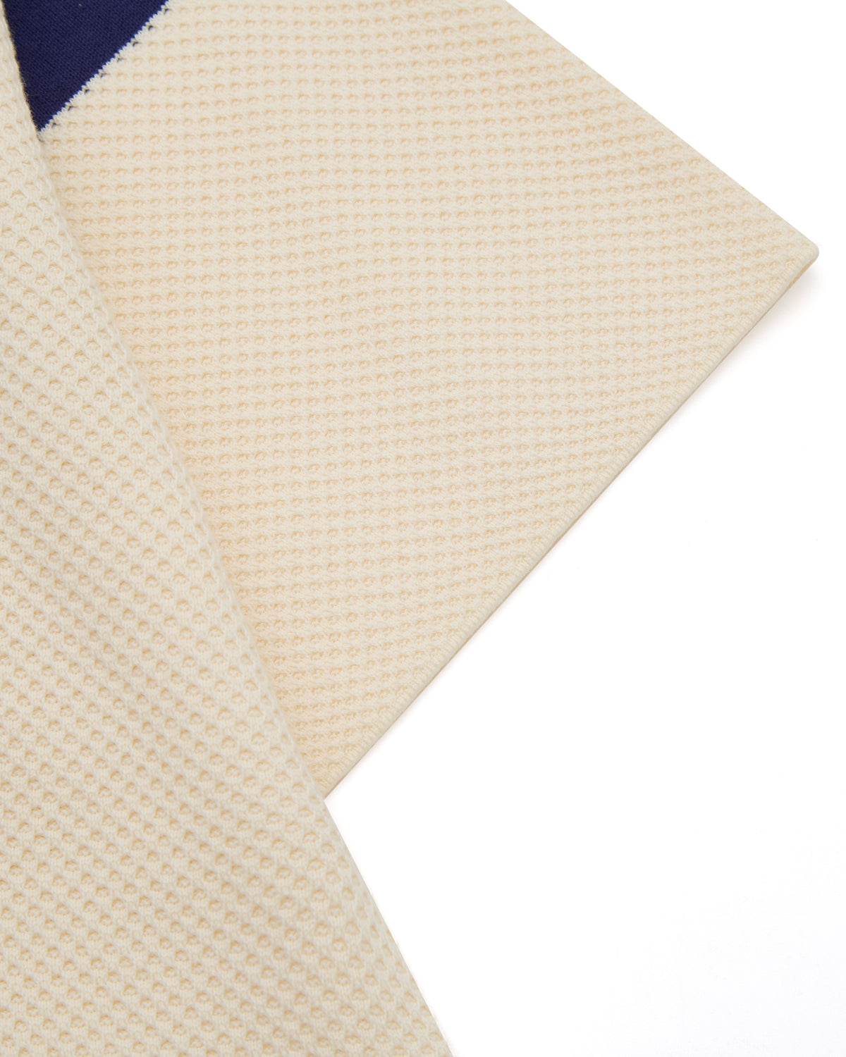 Close-up of a textured beige fabric with a white background
