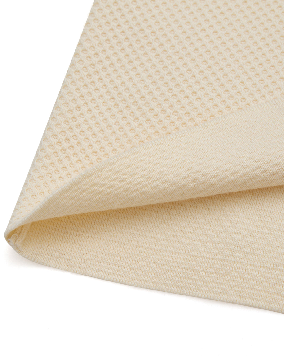 Close-up of beige textured fabric on a white background