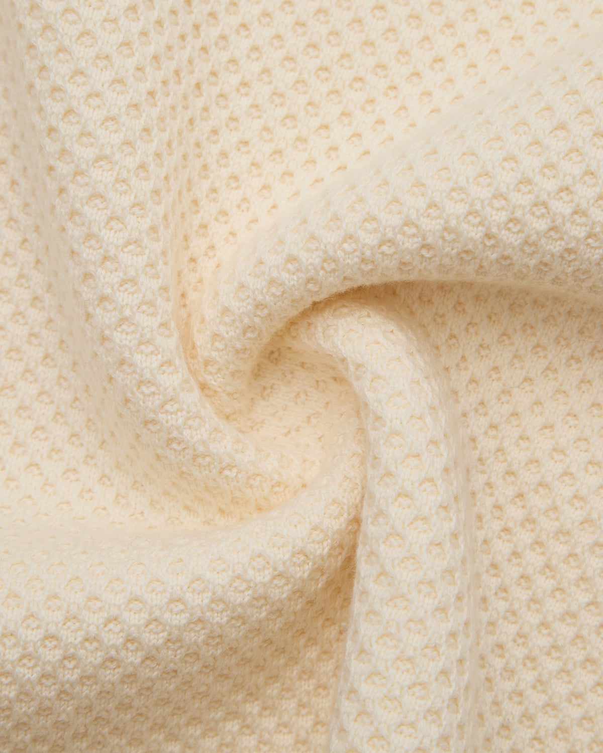 Close-up of beige textured fabric with a subtle pattern