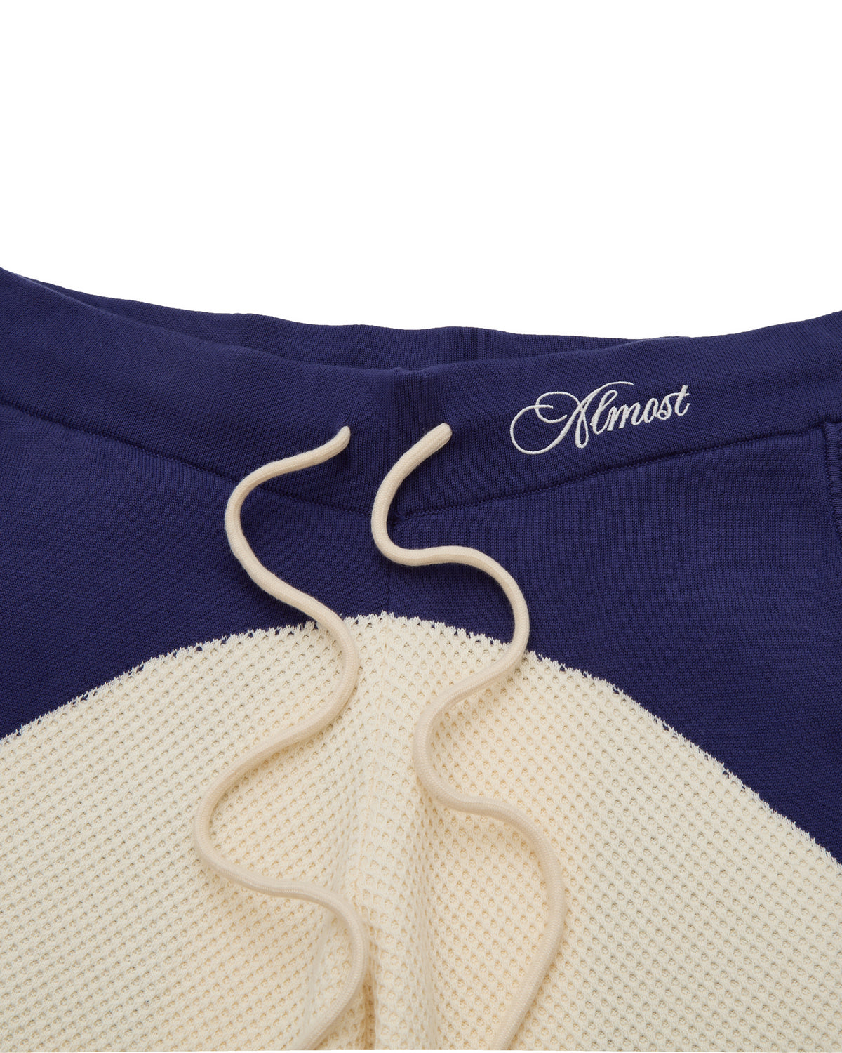 Blue and beige sweatshirt with 'Almost' logo on a white background