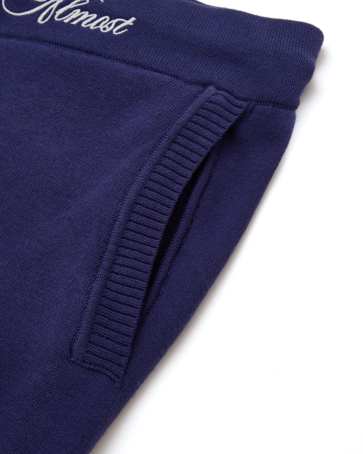 Navy blue shorts with ribbed cuffs on a white background