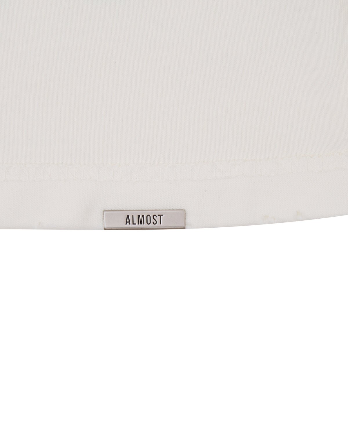 White tshirt with a 'ALMOST' label on a white background