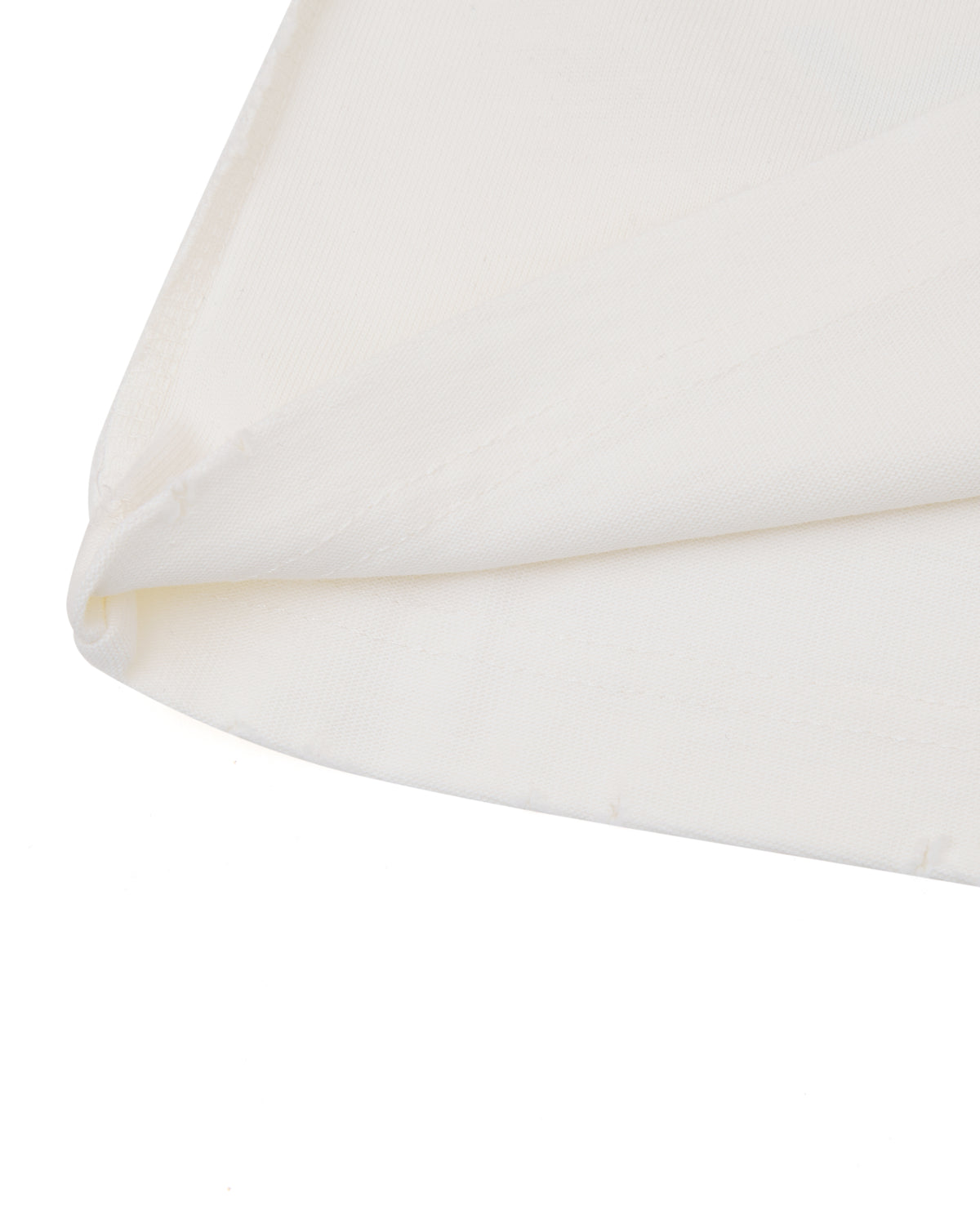Close-up of a white pillow with a subtle pattern on a white background