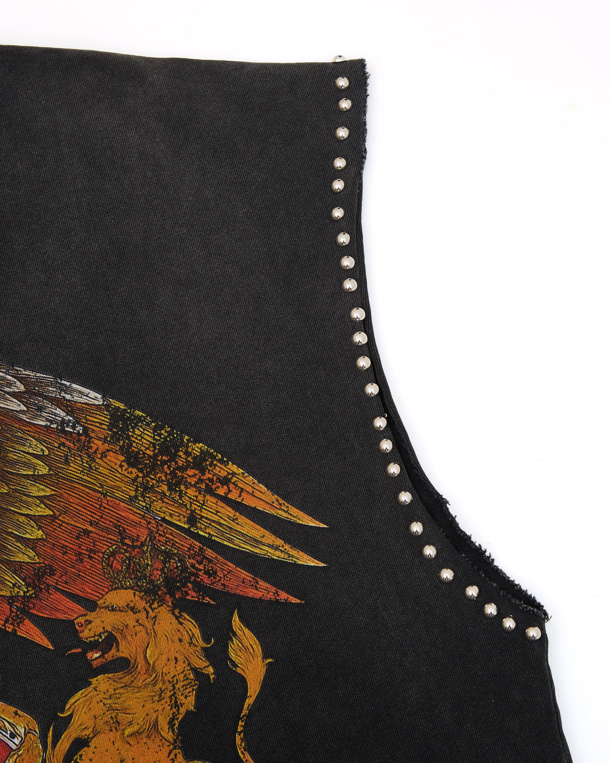 Black sleeveless top with gold eagle and lion design and studded details on a white background