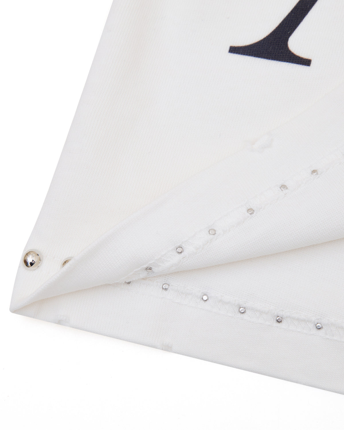 White fabric with decorative studs on a white background