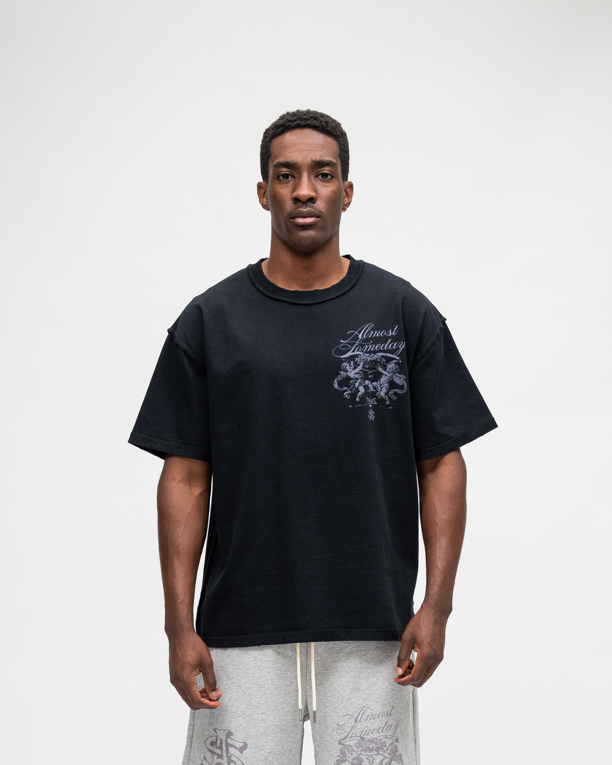 ALMOST SOMEDAY Flourish Tee in Black, front view