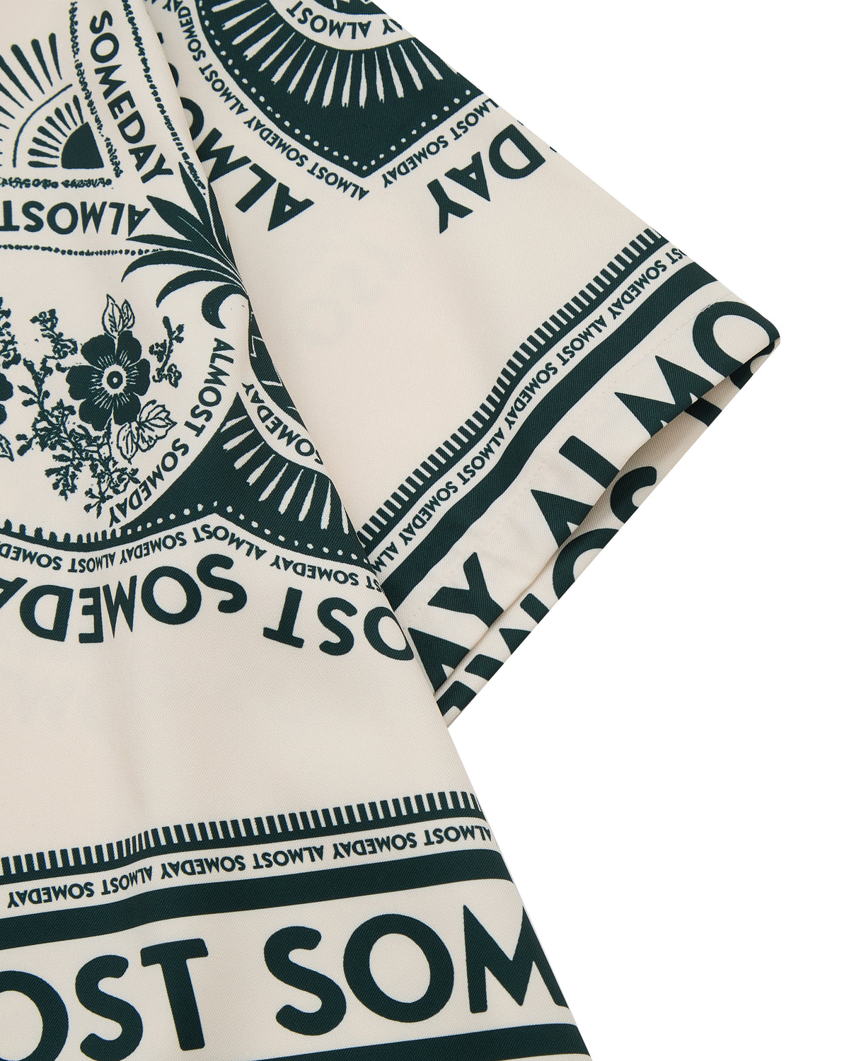 Close-up of a patterned fabric with text and floral designs on a beige background