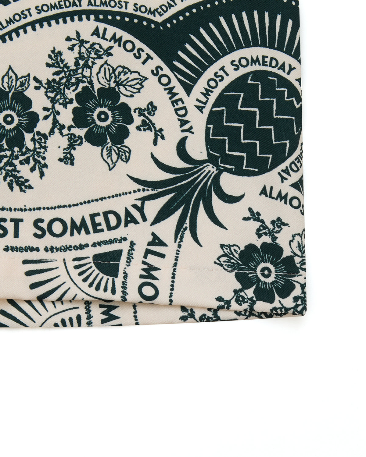 Fabric with 'Almost Someday' text and floral patterns on a white background