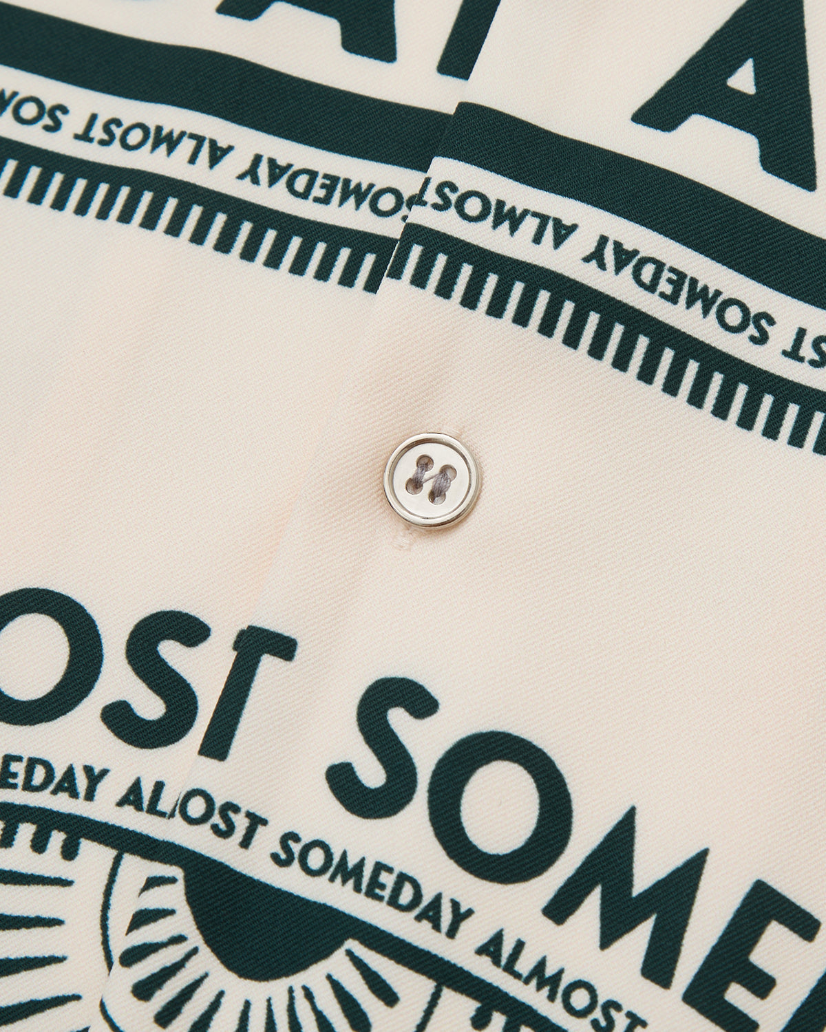 Close-up of a shirt with text and button detail