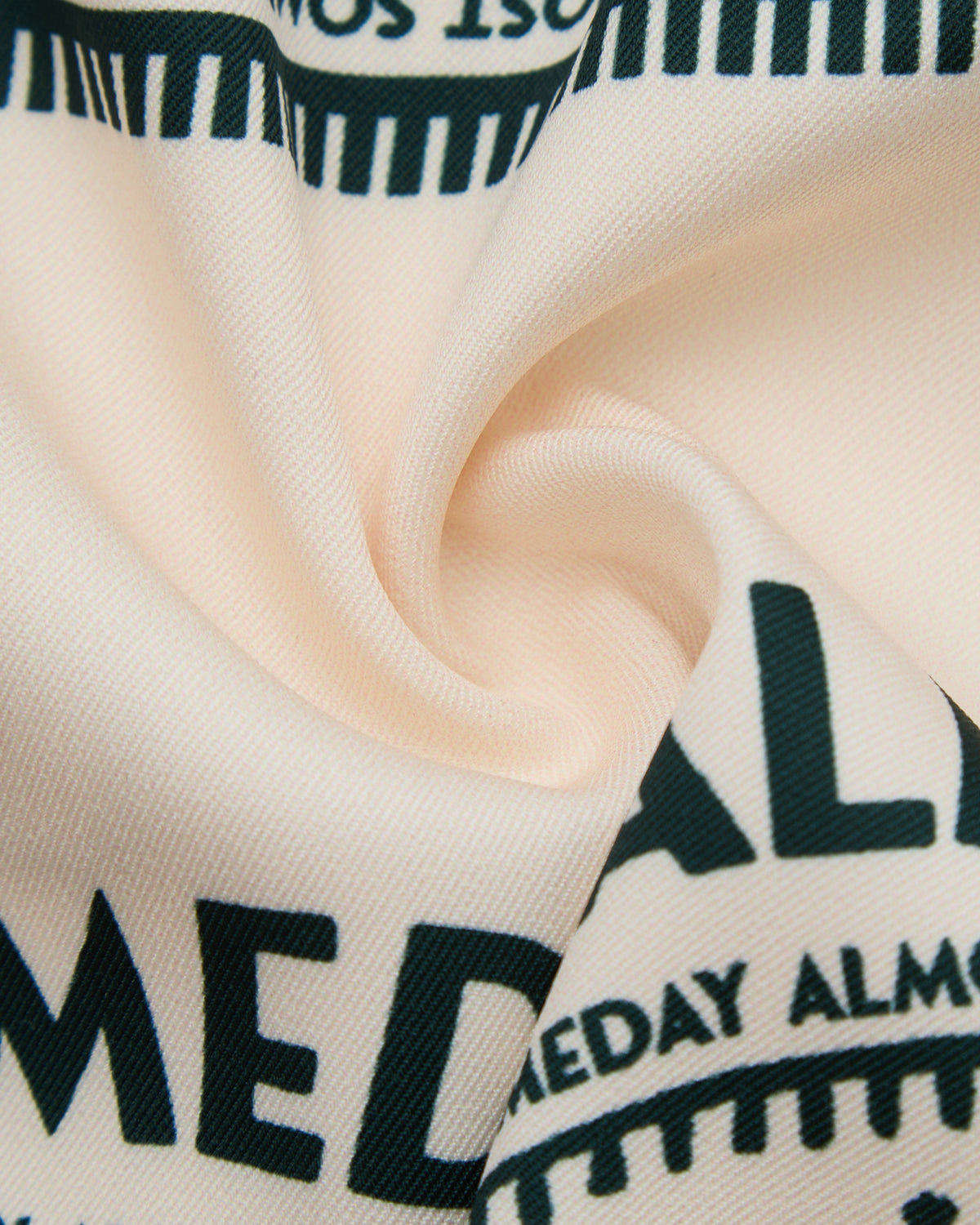 Close-up of beige fabric with black text and stripes
