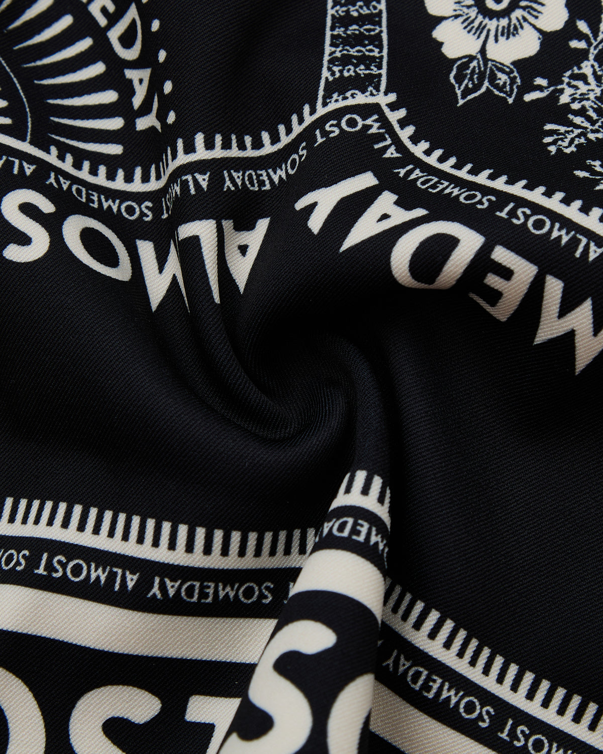 Black fabric with white text and patterns, featuring 'ALMOST SOMEDAY' design.