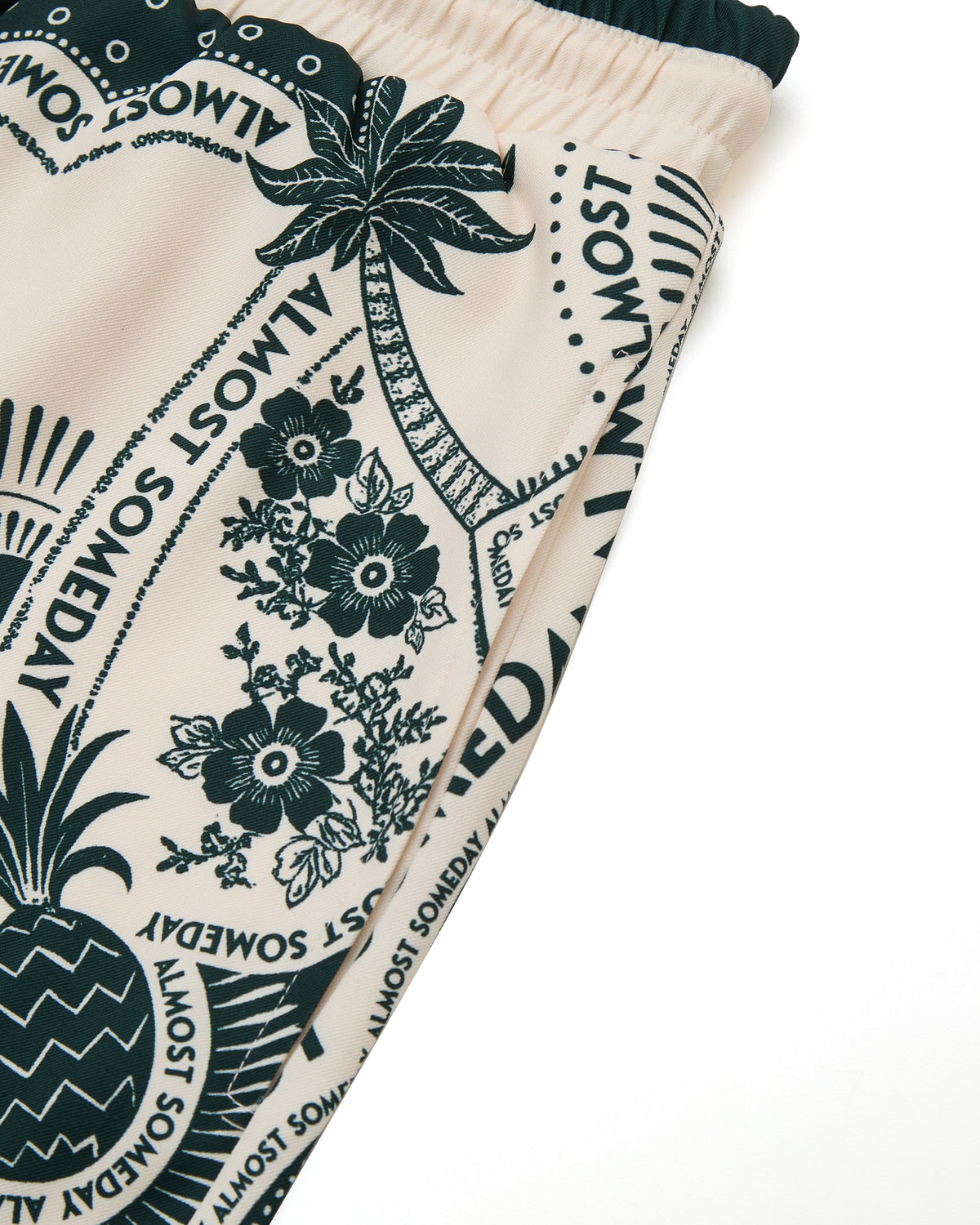 Close-up of a fabric with tropical patterns and text on a white background