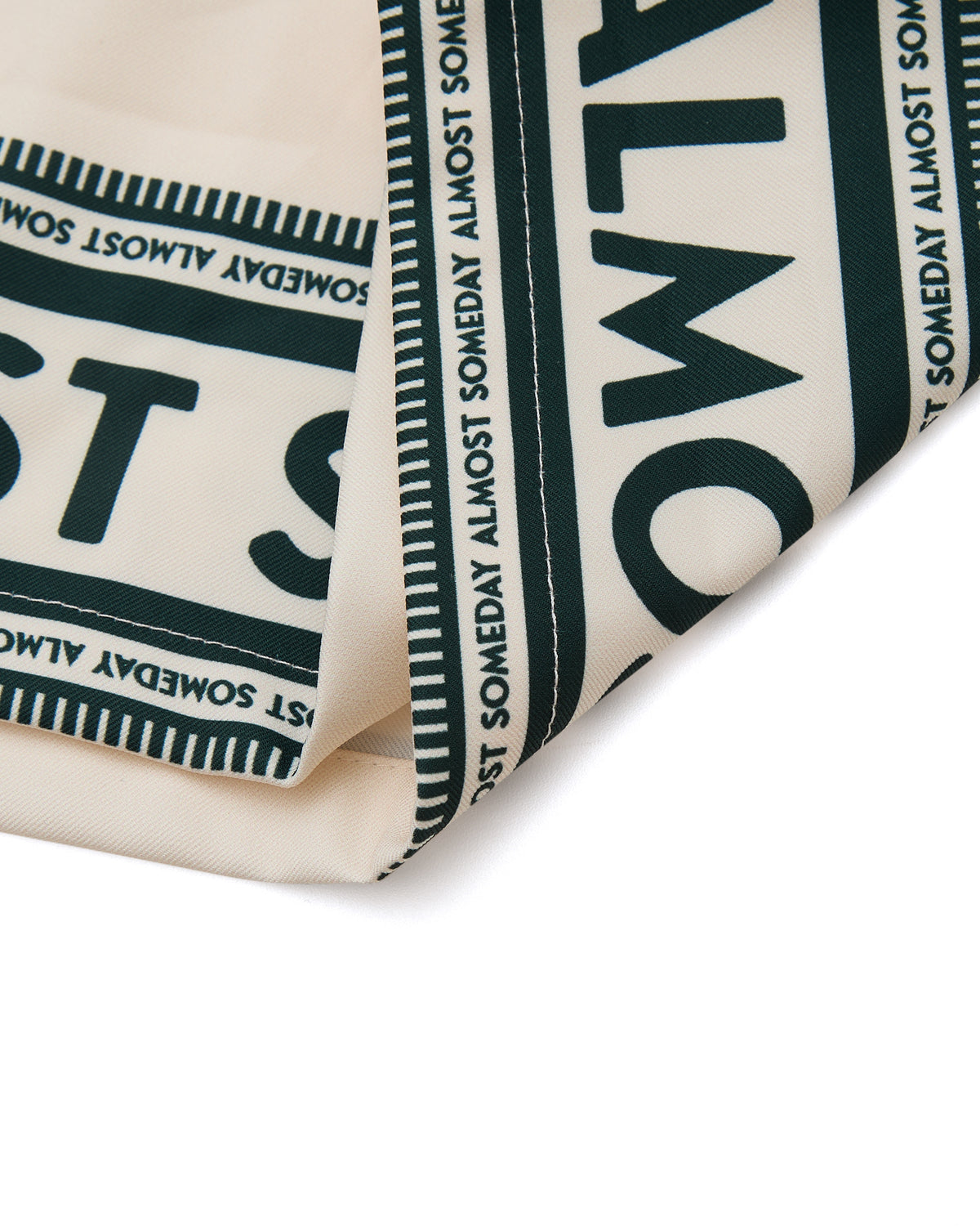 Close-up of a folded fabric with text pattern on a white background
