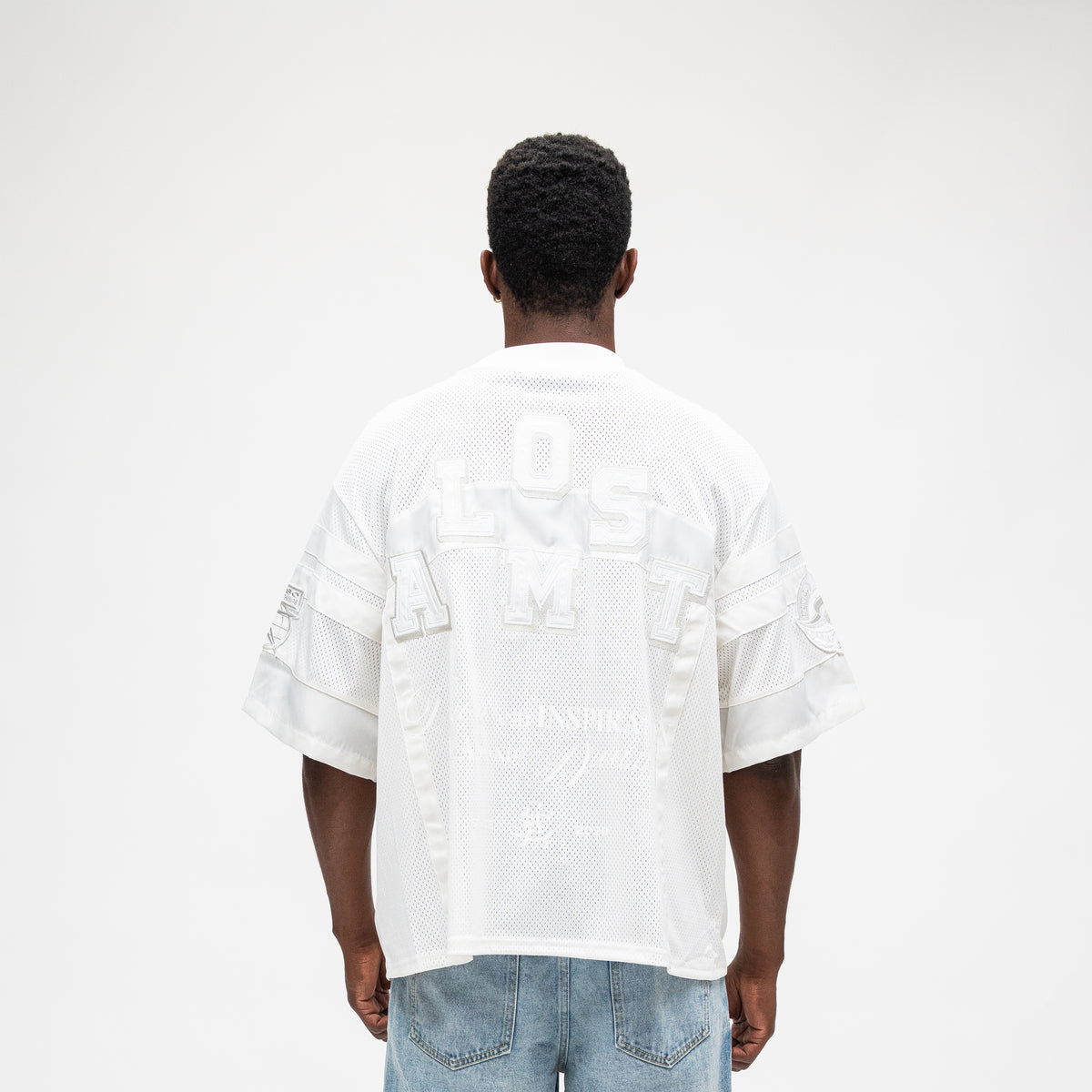 ALMOST SOMEDAY Letterman Jersey Top in Cream, back view with large tonal Almost Someday block letter appliqué across upper back