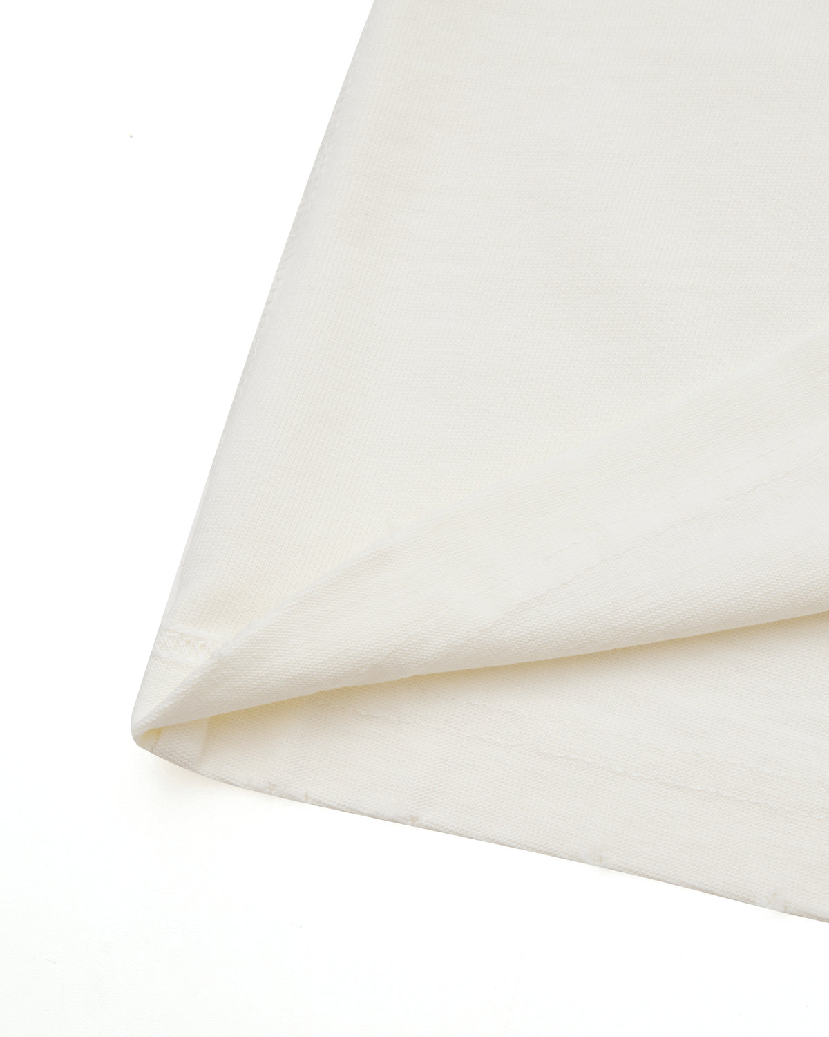 Close-up of cream fabric with a subtle texture on a white background