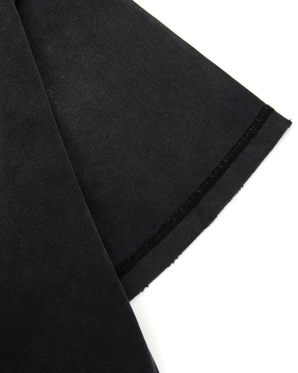 Black fabric with a small orange logo on a white background