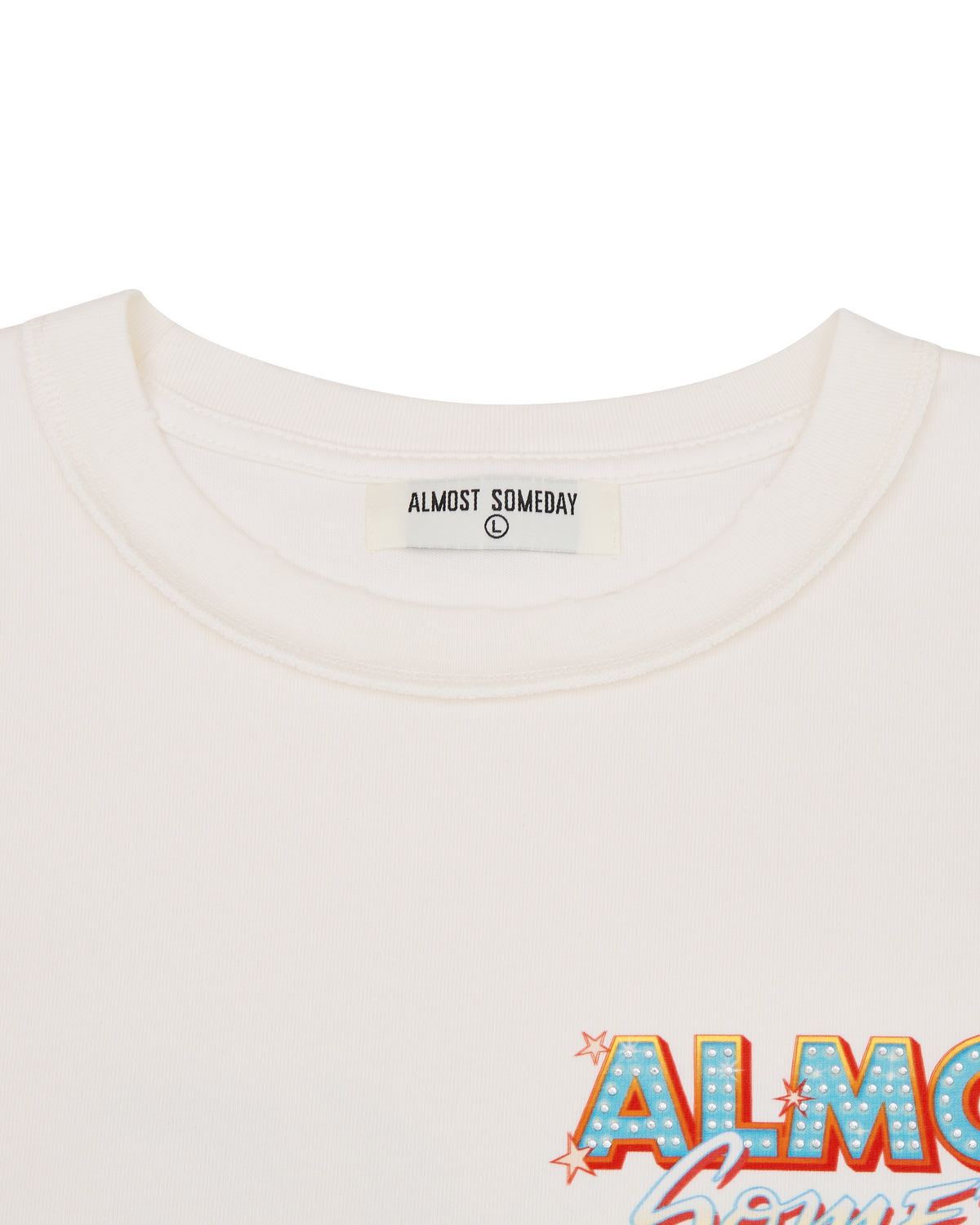 Close-up of a white t-shirt with 'Almost Someday' branding and design.