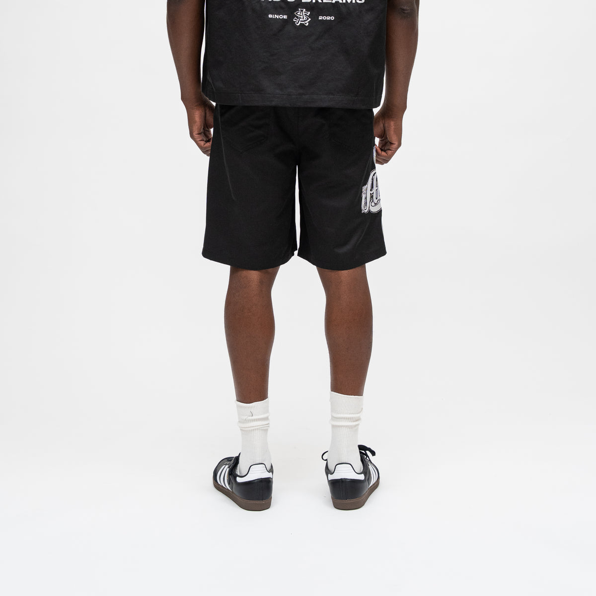 ALMOST SOMEDAY Vision Nylon Short in Black, back view showing relaxed fit and graphic detailing