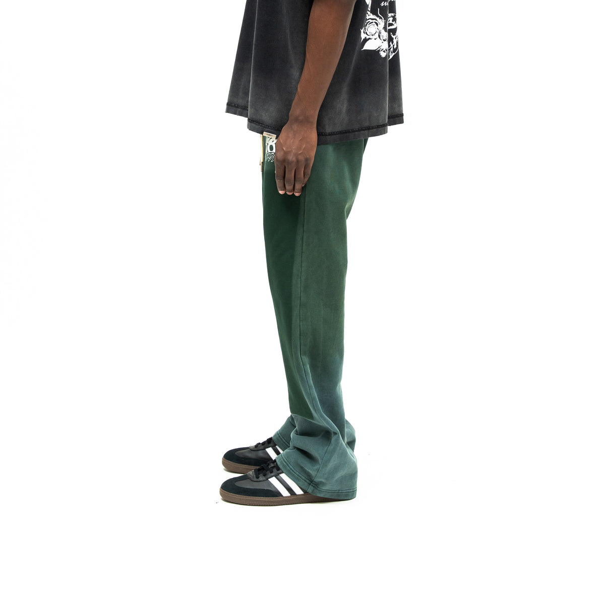 Enemies Flare Bottoms – Green – Side view on model styled with a black tee, showing side seam and flared hem