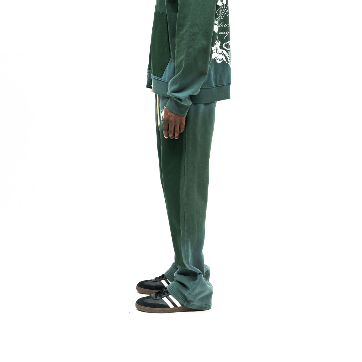 Enemies Flare Bottoms – Green – Side view on model styled with a matching zip hoodie, showing leg silhouette and flared hem