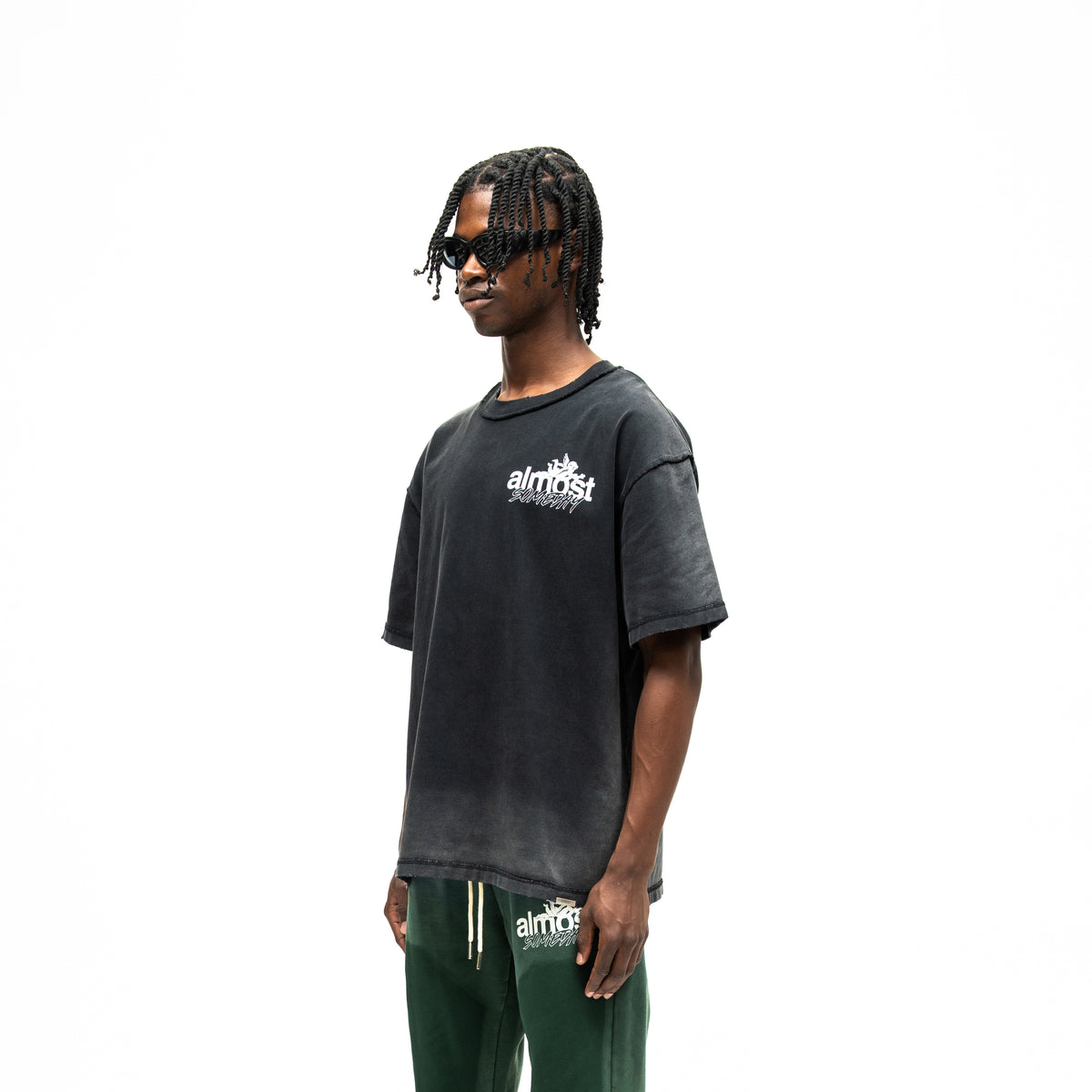 Enemies Tee – Black – Three-quarter front view on model showing chest logo and dropped shoulders