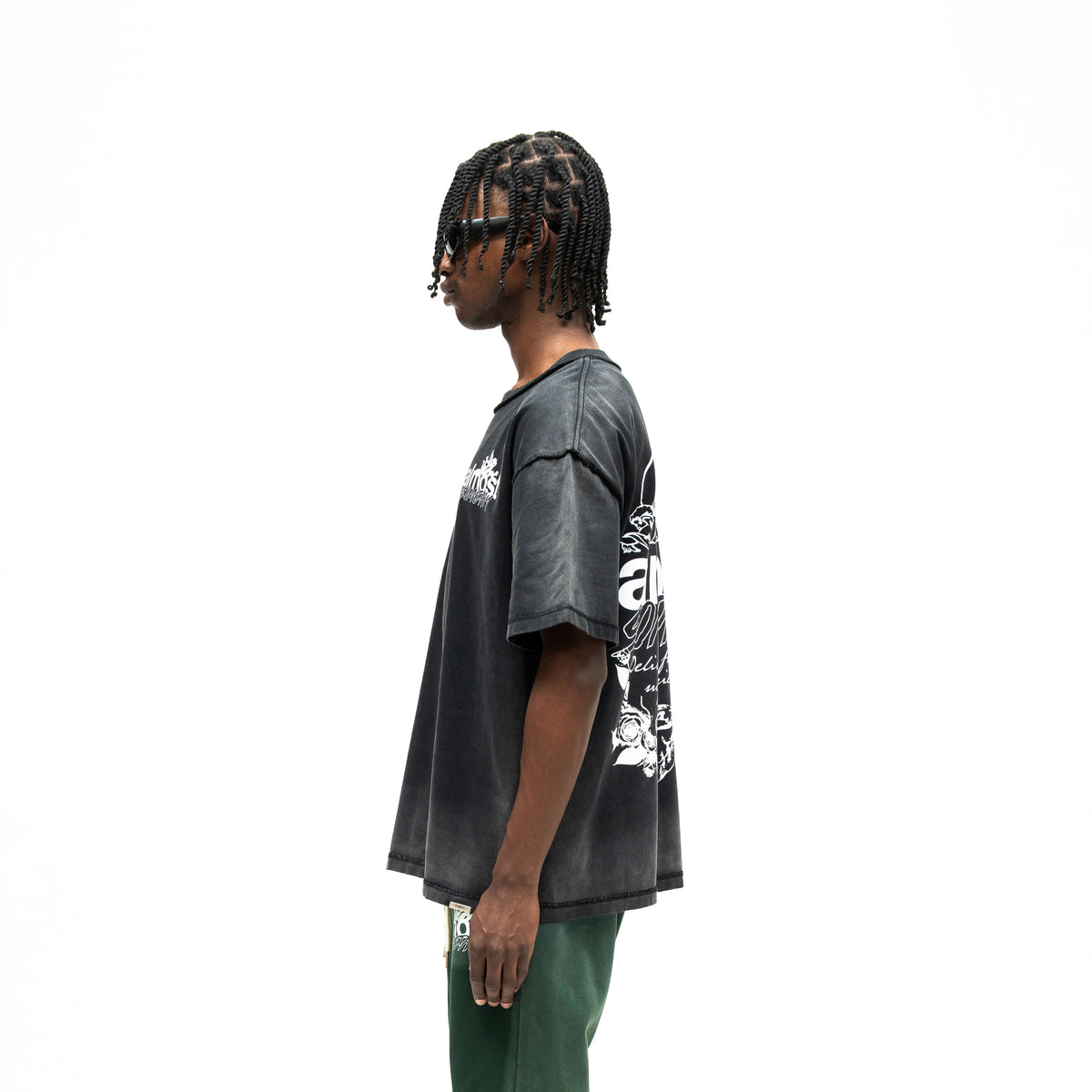 Enemies Tee – Black – Side view on model showing short sleeves, relaxed silhouette, and partial back graphic