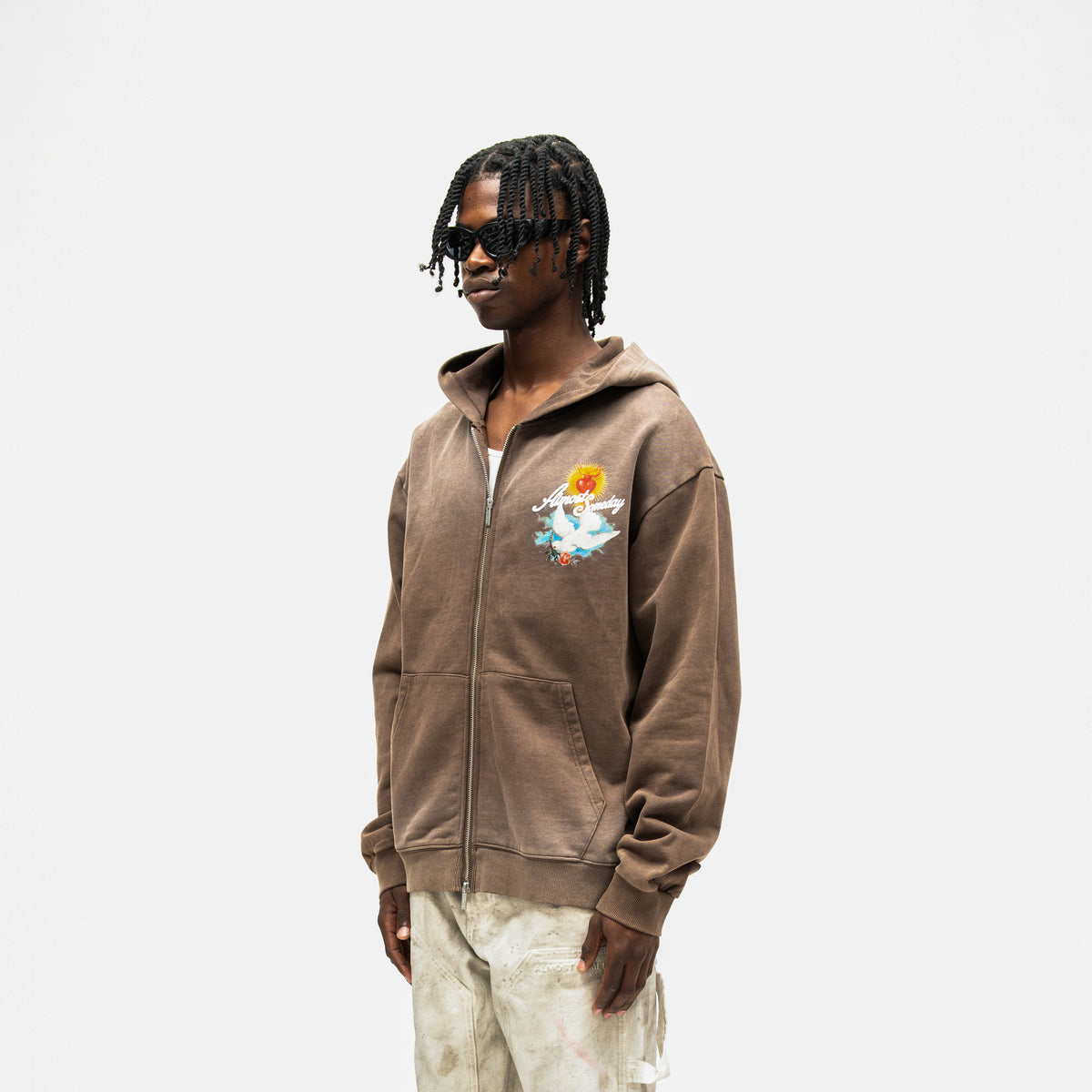 Fountain Hoodie – Brown – Three-quarter front view on model showing chest artwork, dropped shoulders, and ribbed hem