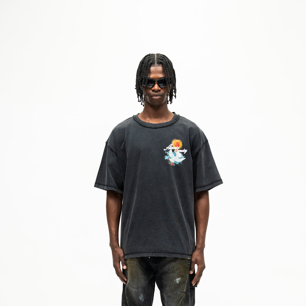 Fountain Tee – Black – Front view on model showing colorful chest graphic, short sleeves, and boxy fit