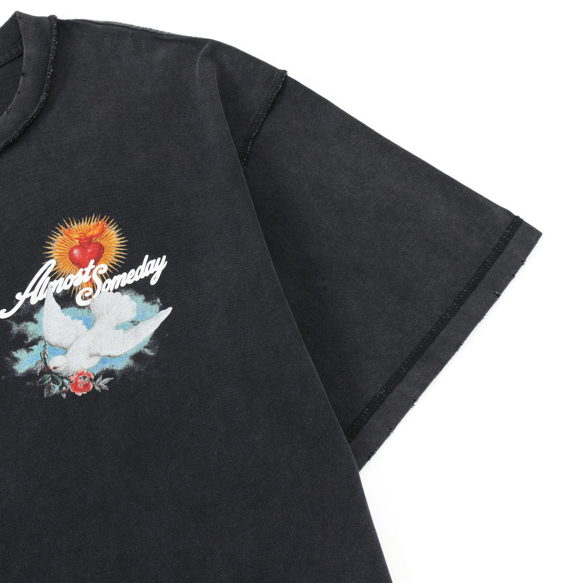 Fountain Tee – Black – Close-up of chest graphic, shoulder seam, and distressed sleeve edge
