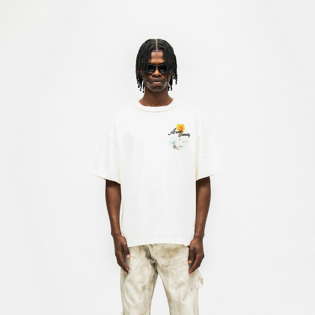 Fountain Tee – Cream – Front view on model showing chest graphic and relaxed fit