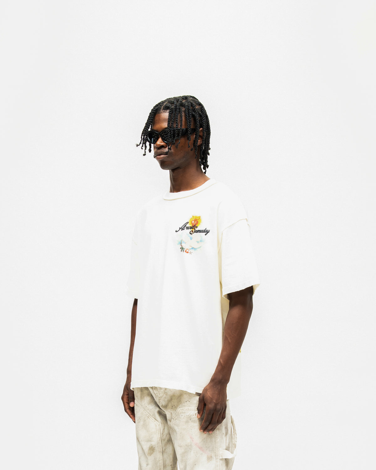 Fountain Tee – Cream – Three-quarter front view on model showing chest graphic and short sleeves