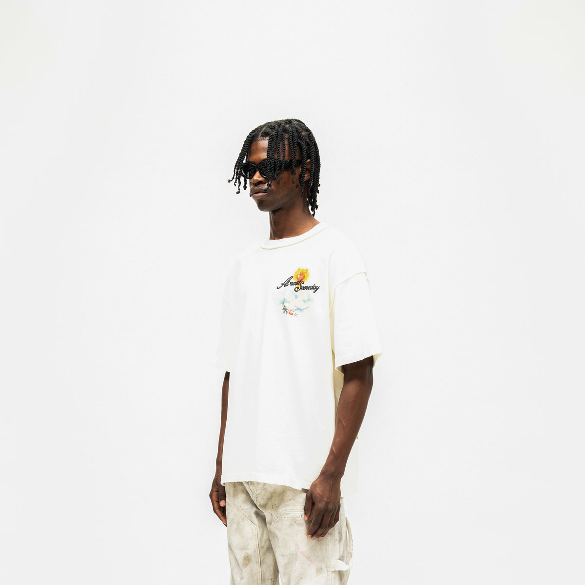 Fountain Tee – Cream – Three-quarter front view on model showing chest graphic and short sleeves
