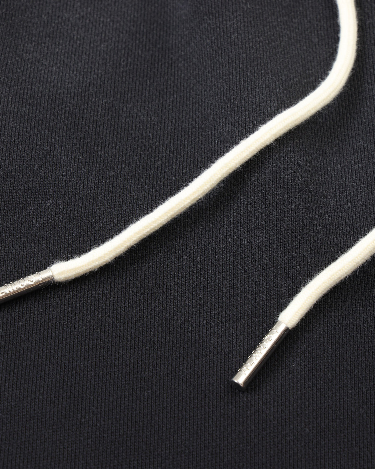League Flare Sweatpants – Black – Close-up of white drawstrings with silver-tone metal tips