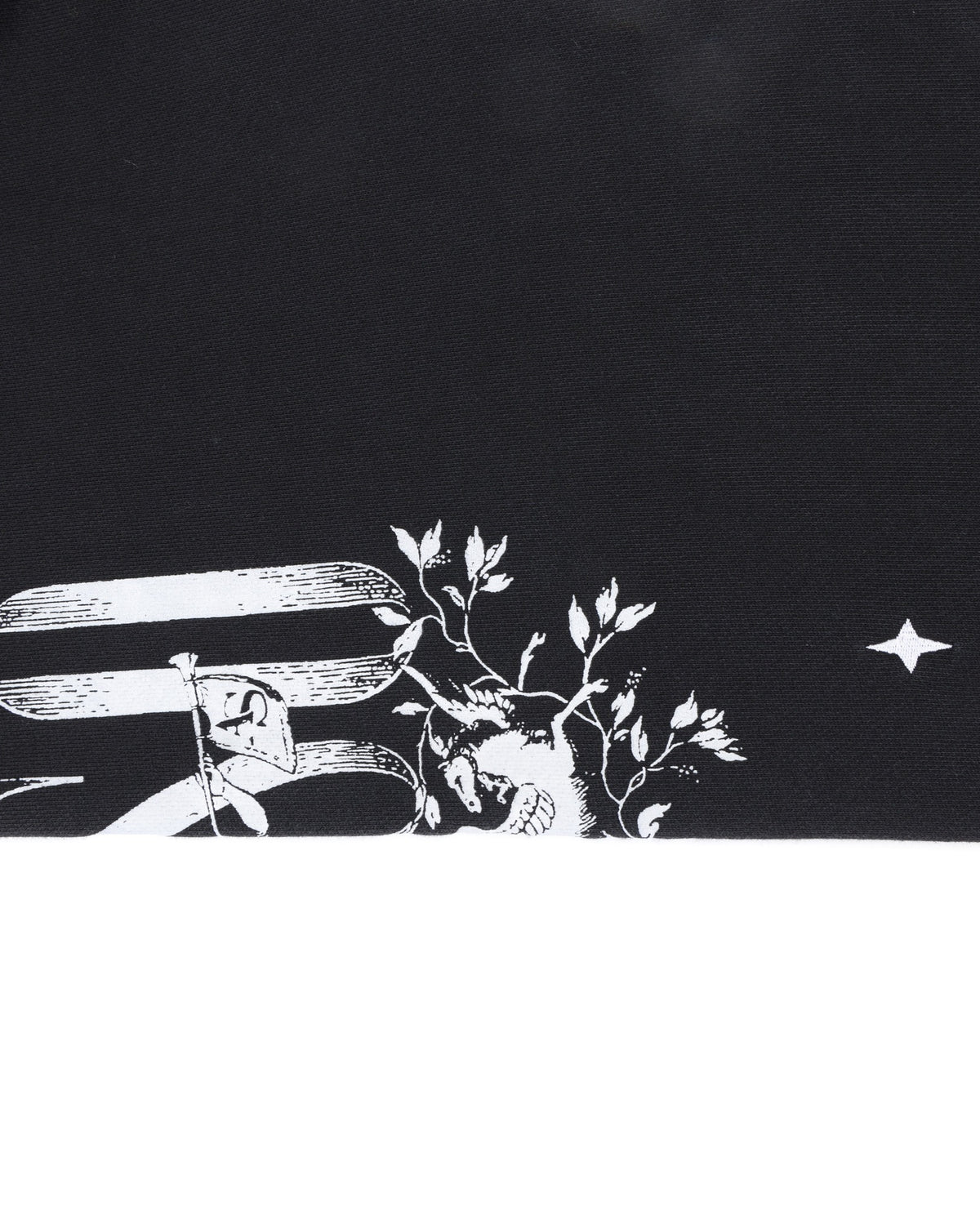 League Flare Sweatpants – Black – Close-up of leg fabric with partial white lettering, winged figure, and star graphic