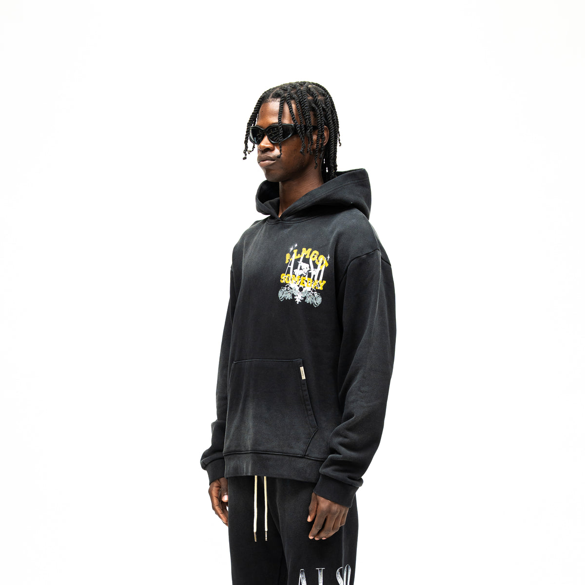 League Hoodie – Black – Three-quarter front view on model showing chest graphic and dropped shoulders
