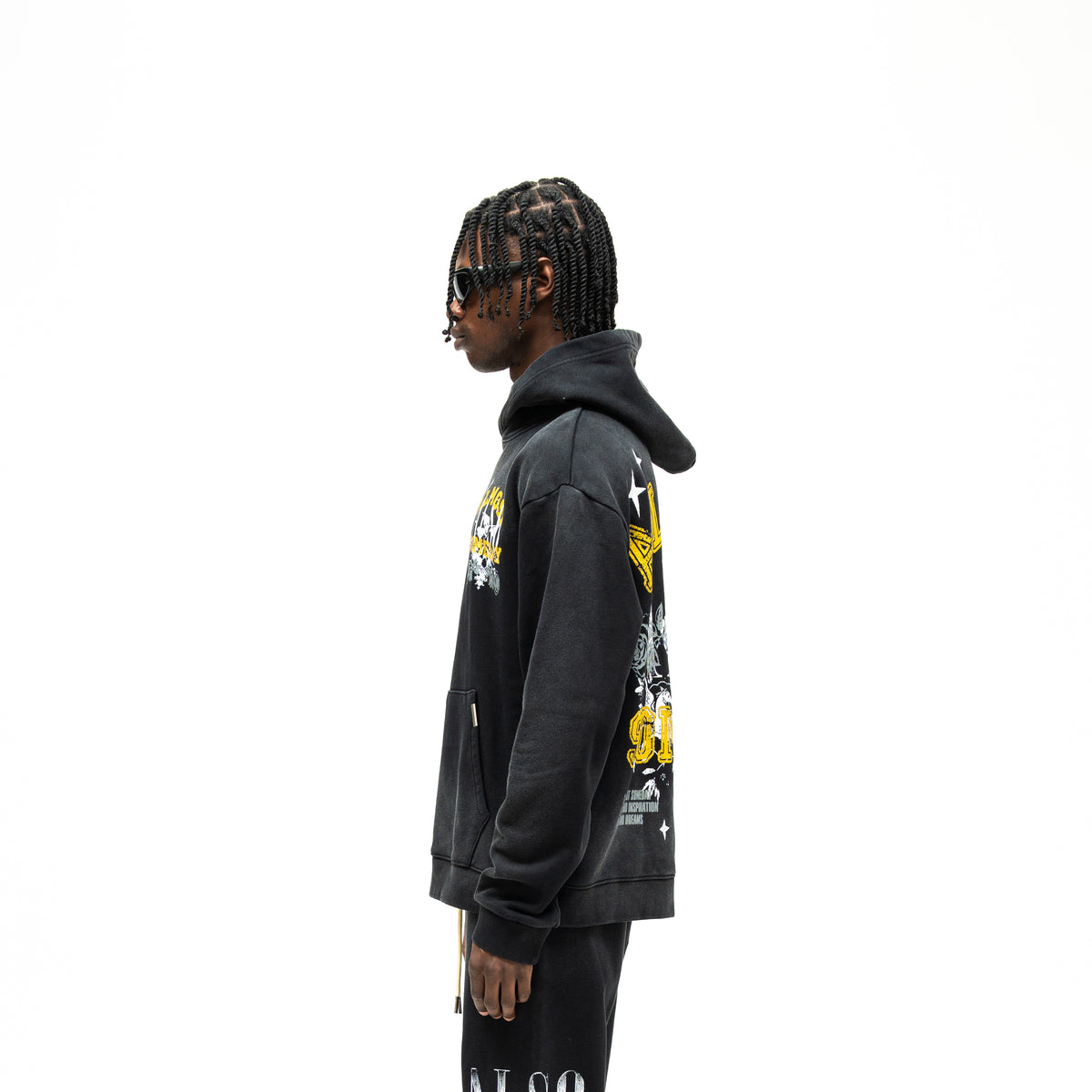 League Hoodie – Black – Side view on model showing hood, long sleeves, and partial back graphic