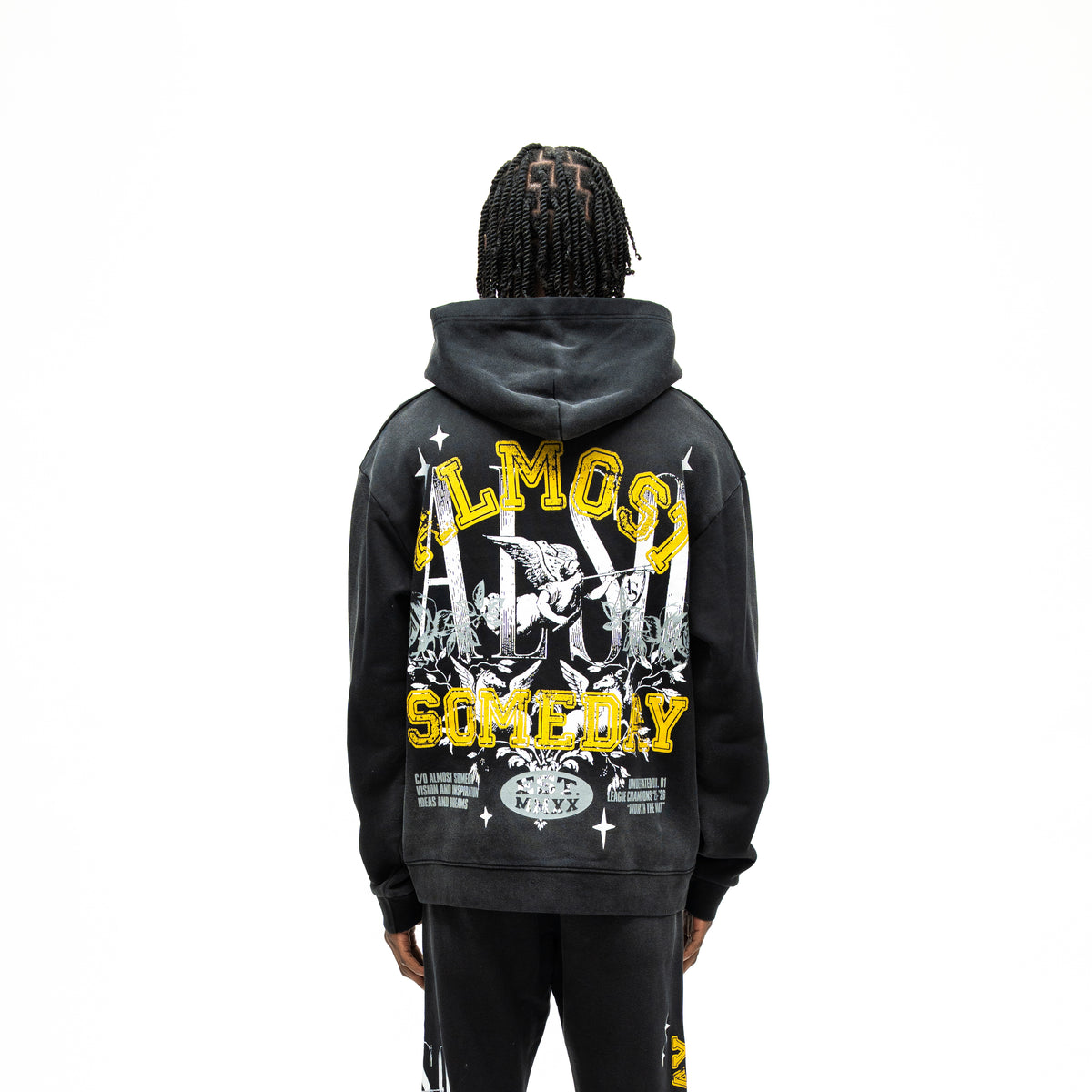 League Hoodie – Black – Back view on model showing large yellow lettering, cherub, roses, and stars