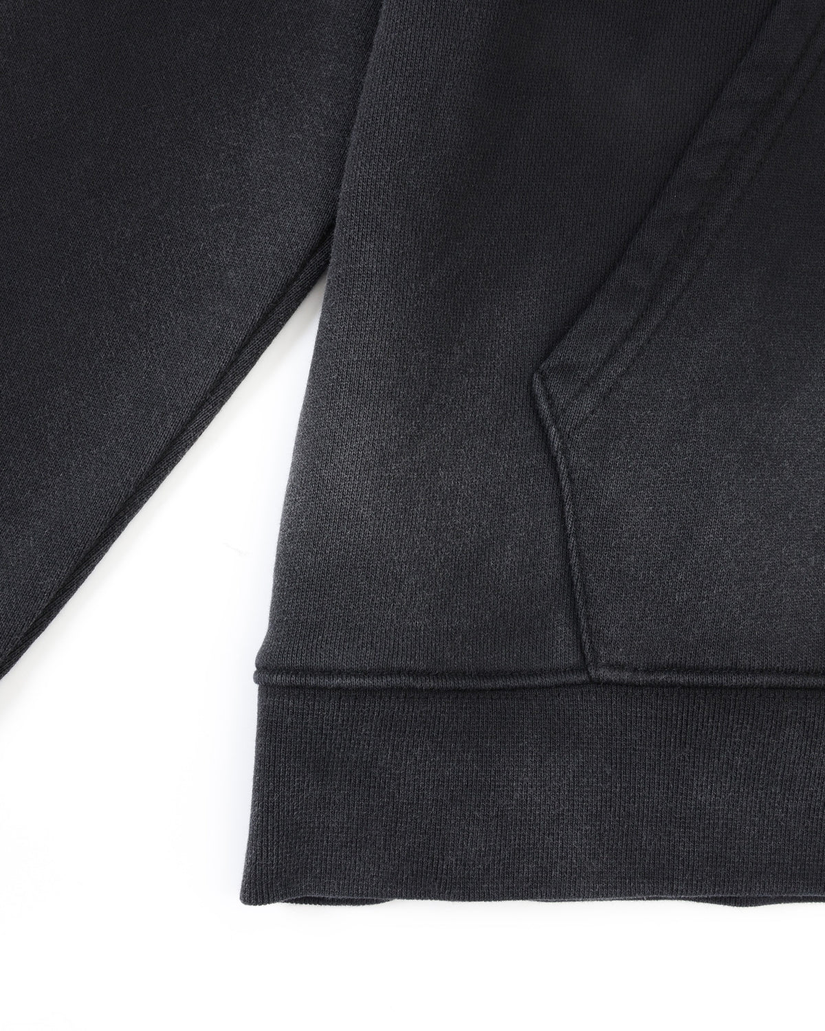 League Hoodie – Black – Close-up of kangaroo pocket seam and ribbed bottom hem