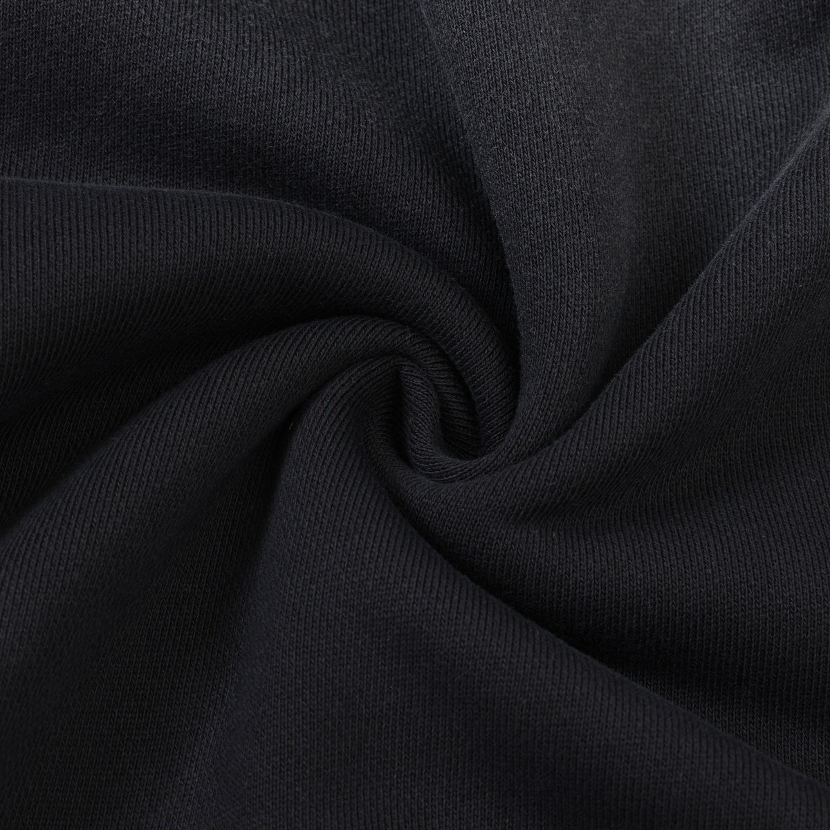 League Hoodie – Black – Close-up of black fabric gathered to show texture