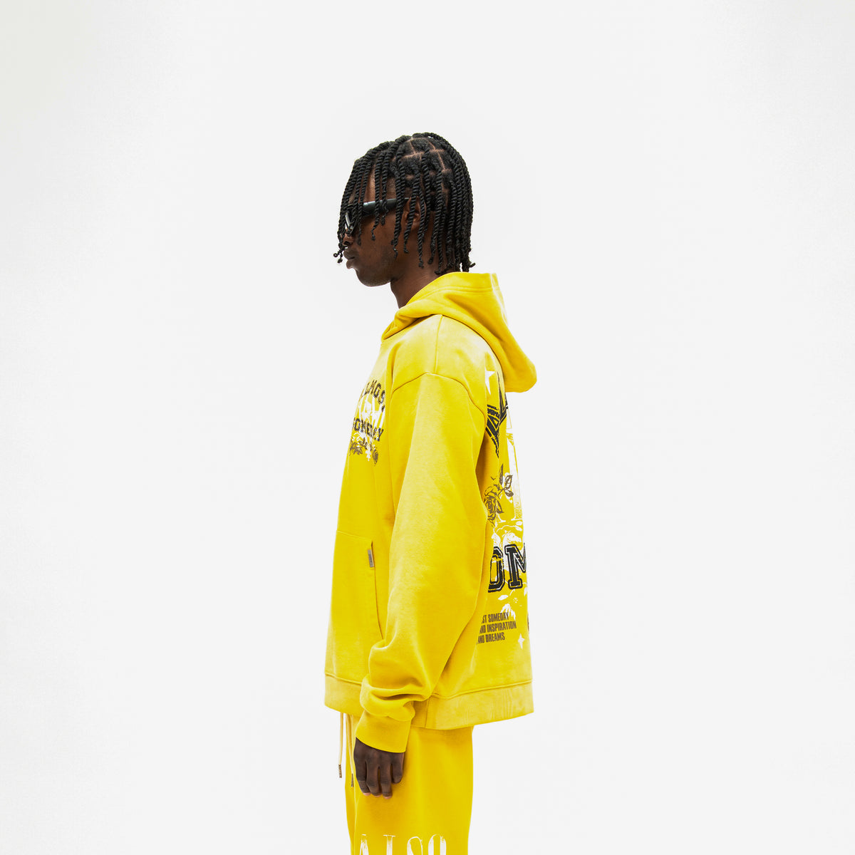 League Hoodie – Yellow – Side view on model showing hood, long sleeves, and partial back graphic