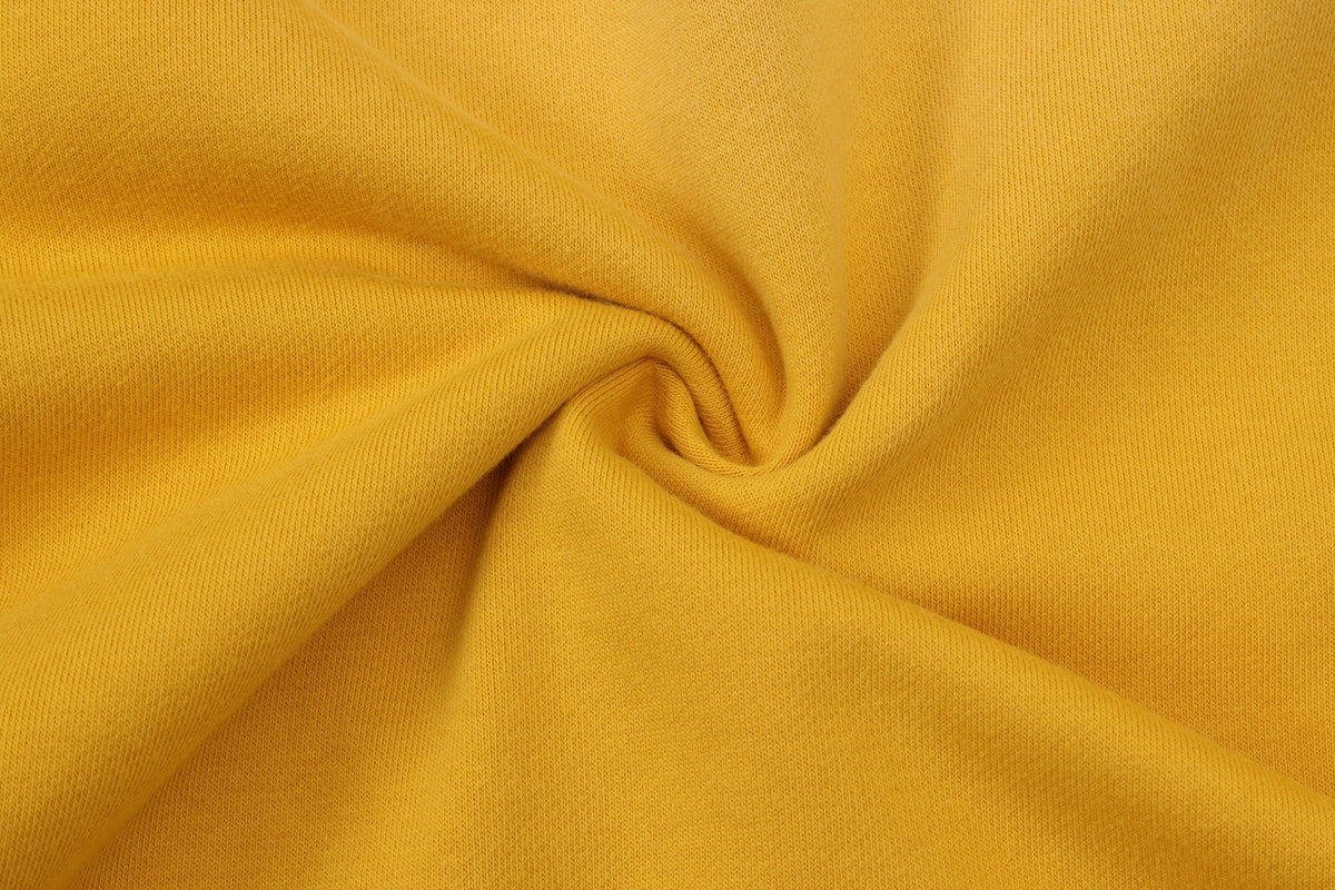 League Hoodie – Yellow – Close-up of yellow fabric gathered to show texture
