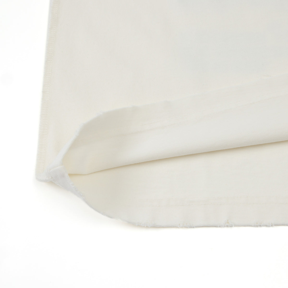 League Tee – Cream – Close-up of folded bottom hem and fabric edge