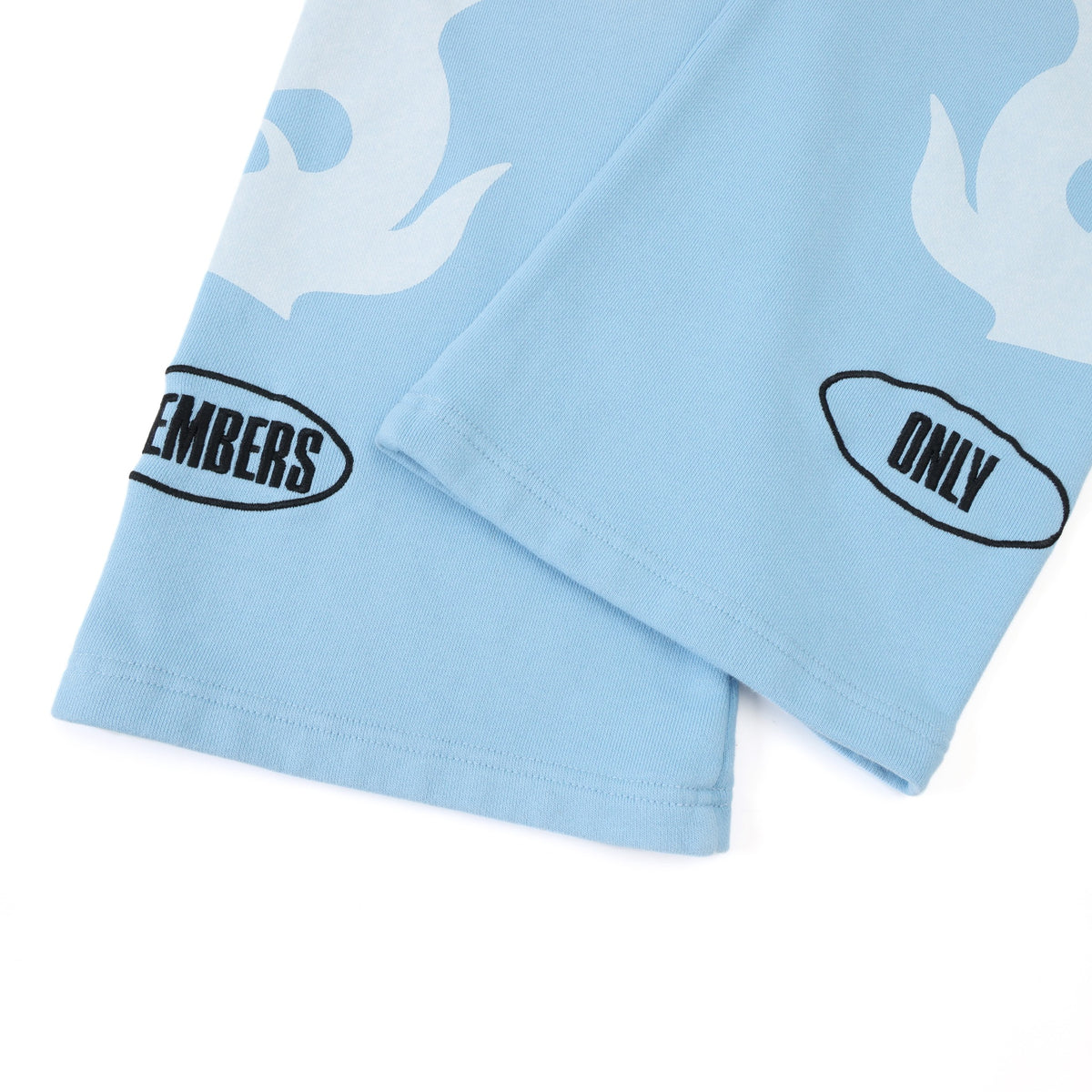 Members Flare Sweatpants – Light Blue – Close-up of flared hems with white flames and black Members Only embroidery