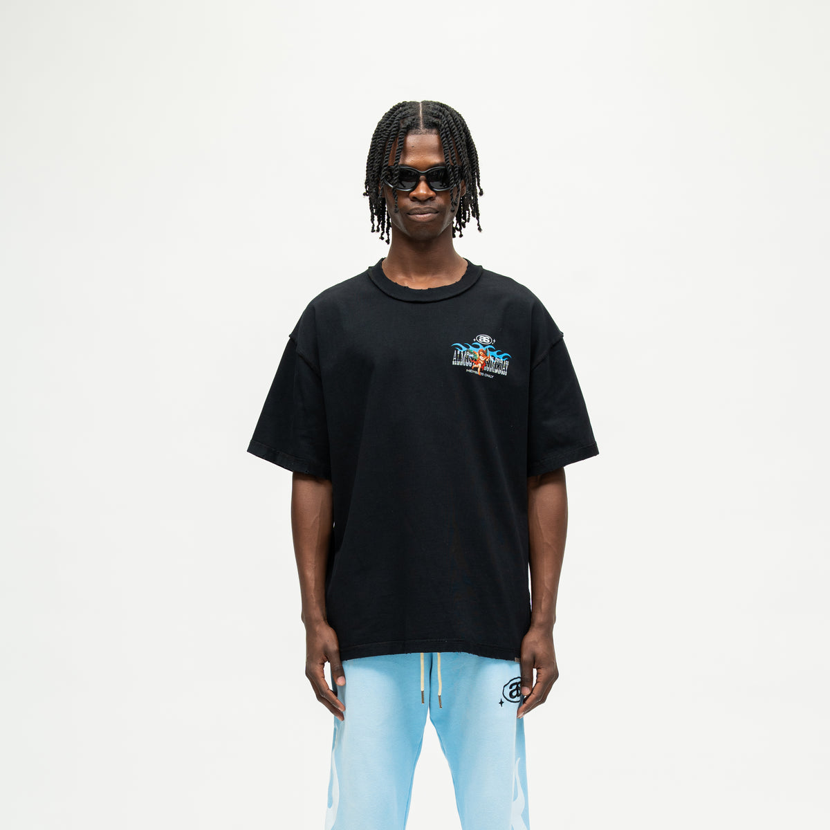 Members Tee – Black – Front view on model showing small chest graphic, crew neckline, and wide short sleeves