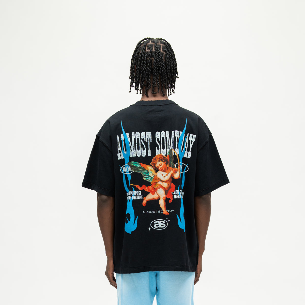 Members Tee – Black – Back view on model showing winged cherub with bow, blue flames, and Almost Someday lettering