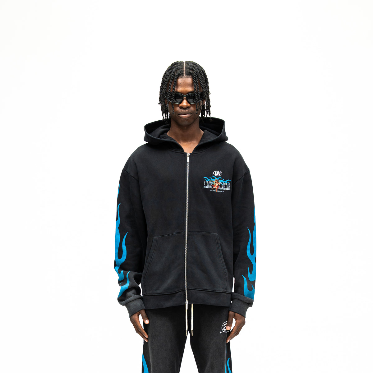 Members Zip Hoodie – Black – Front view on model showing zip closure, chest graphic, front pockets, and blue sleeve flames