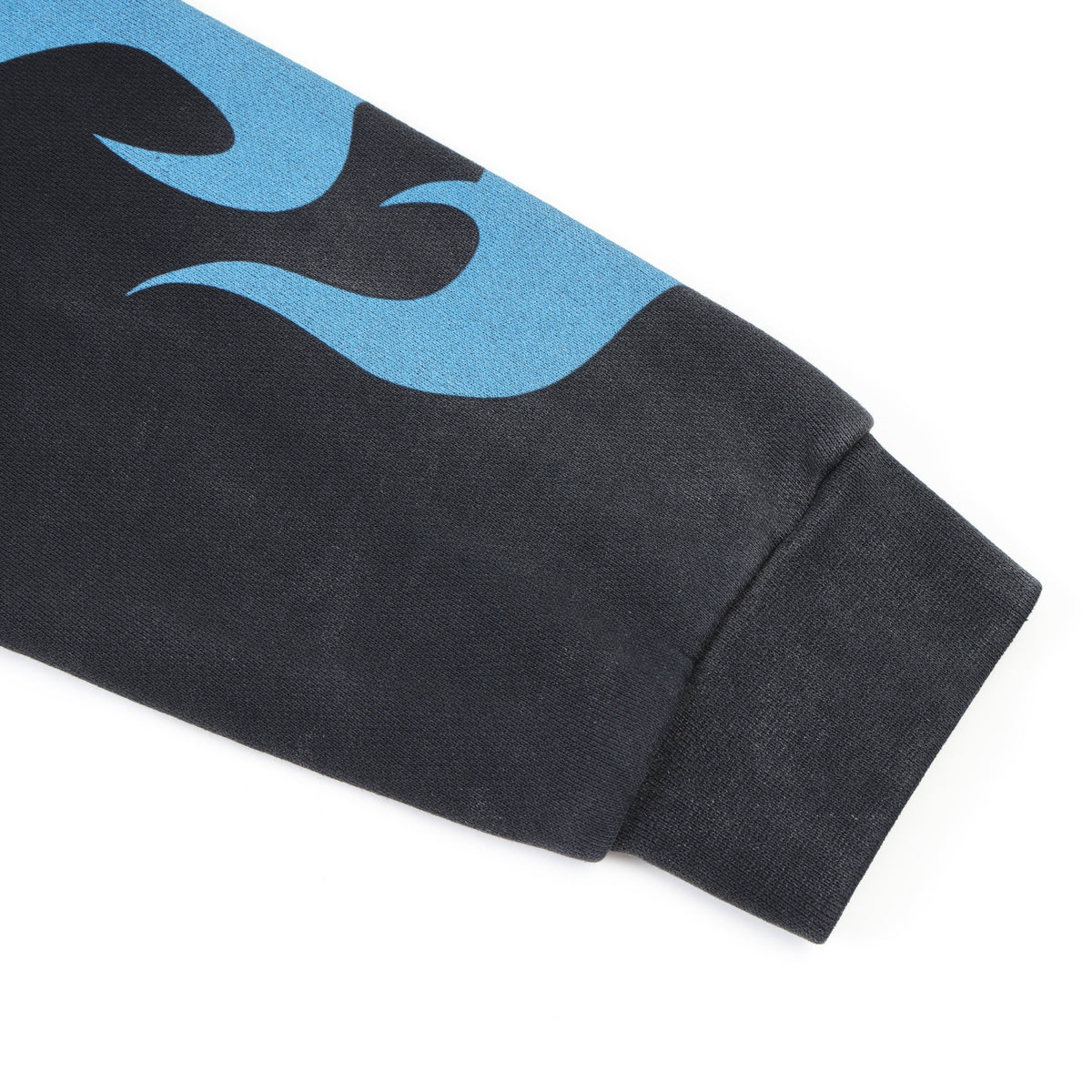 Members Zip Hoodie – Black – Angled close-up of ribbed cuff and blue sleeve flame